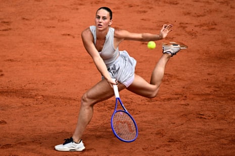 Ukraine's Marta Kostyuk plays a forehand return to Poland's Iga Swiatek.