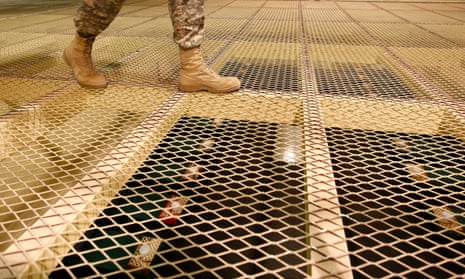 A US soldier walks above detention centre cells at Bagram air base.