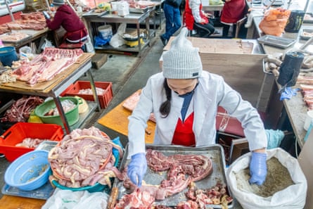 Salty garlic is added to horsemeat to prepare qazy, a horse sausage, at the meat market in Altyn Orda, Almaty.