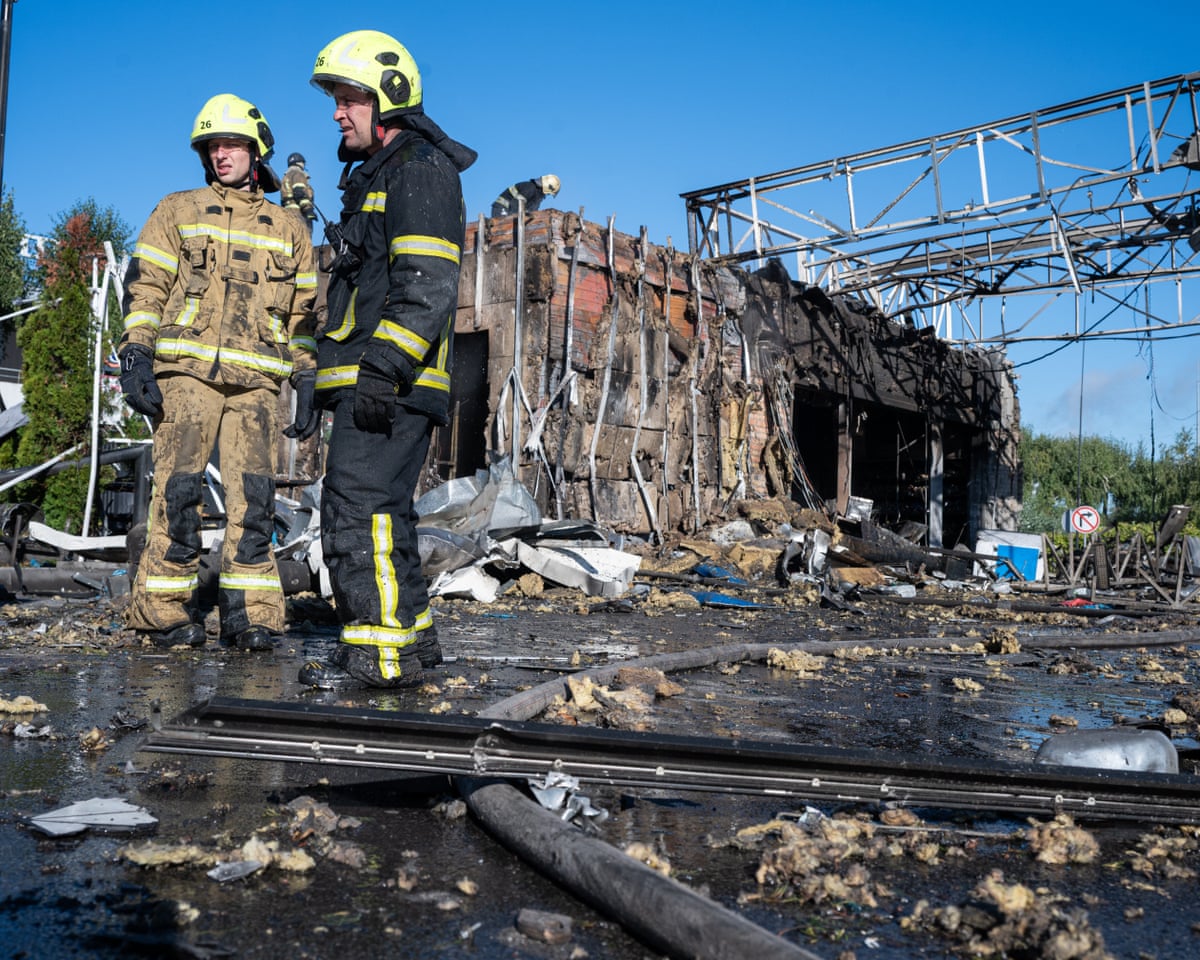 Emergency rescue workers and municipal response teams inspect and clear the debris of a heavily damaged gas station and business center following Russian air and missile strikes across Kyiv, Ukraine.