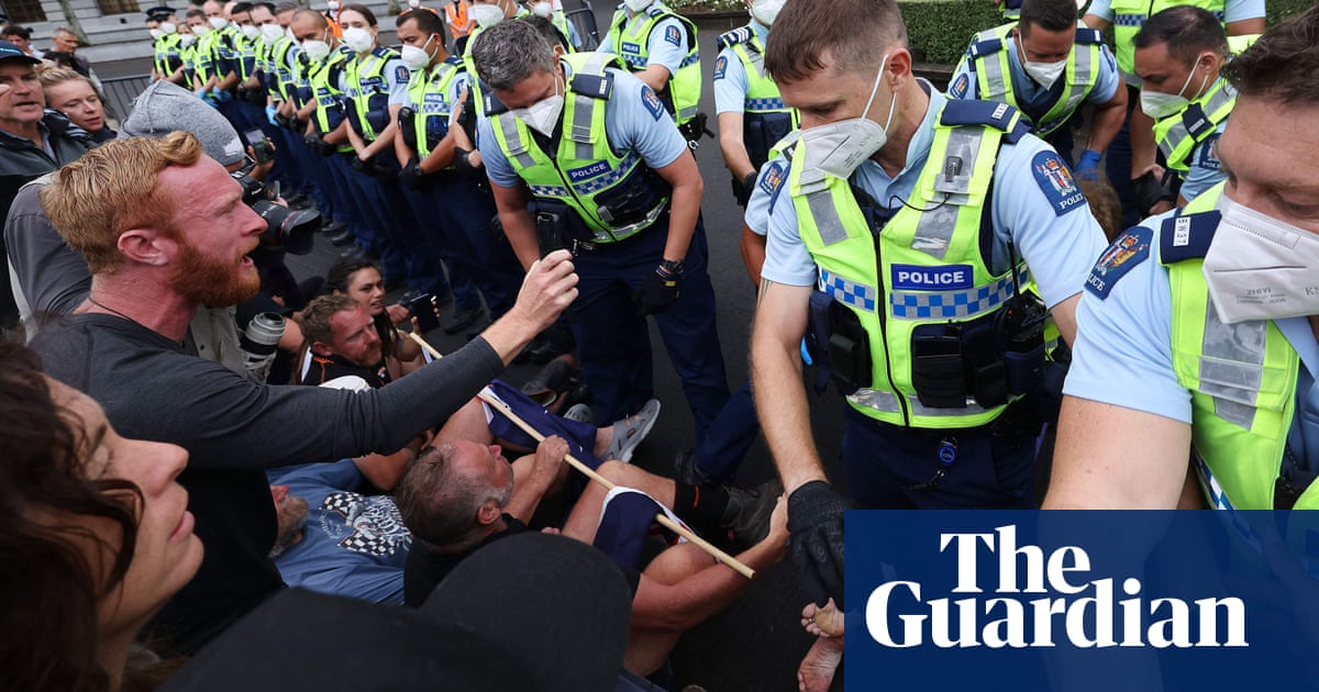 Anti-vaccine protesters clash with police outside New Zealand parliament – video