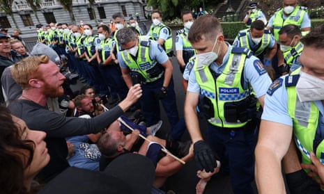 NZEALAND-HEALTH-VIRUS-PROPolice move in to evict people protesting against Covid restrictions outside parliament in Wellington, New Zealand.TEST-DEMONSTRATION<br>Police move in to evict mandate protesters in parliament grounds in Wellington on February 10, 2022, on the third day of demonstrations against Covid-19 restrictions, inspired by a similar demonstration in Canada. (Photo by Marty MELVILLE / AFP) (Photo by MARTY MELVILLE/AFP via Getty Images)