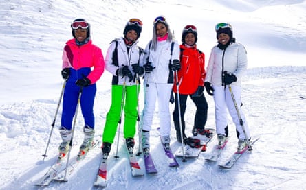 Five women on skis on a mountain.