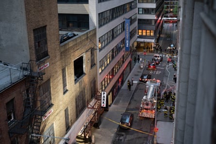 overhead view of street with fire engines and building with missing window
