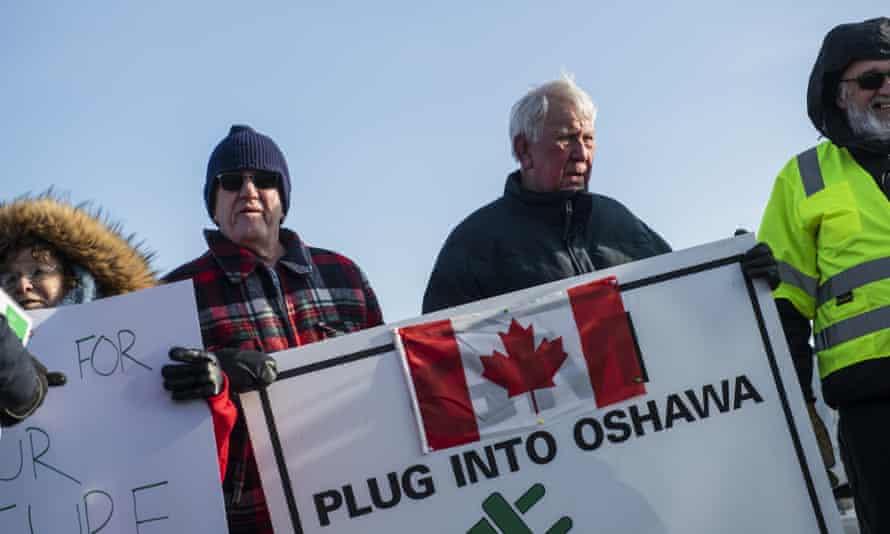 Activists hold signs outside the General Motors plant in Oshawa, Ontario, on the final day of production on 18 December.