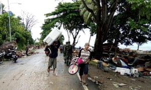 Residents evacuate from damaged homes on Carita beach in Indonesia after a tsunami that may have been caused by the Anak Krakatoa volcano. 