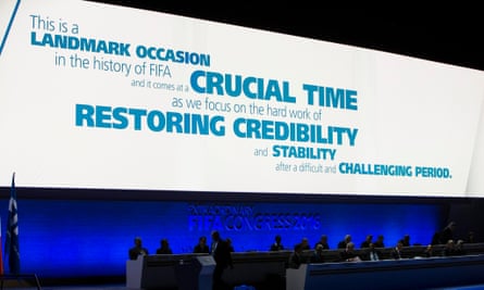 Delegates at the conference under a large sign carrying a message abut the ‘landmark occasion’ aimed at ‘restoring credibility’