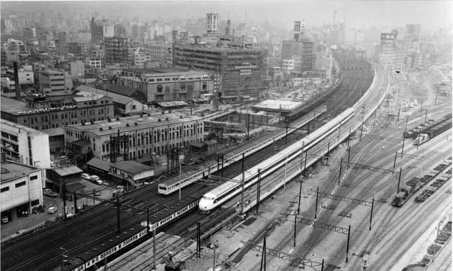 A shinkansen bullet train runs toward Tokyo Station past Shiodome Freight Terminal during a test run on in July 1964.