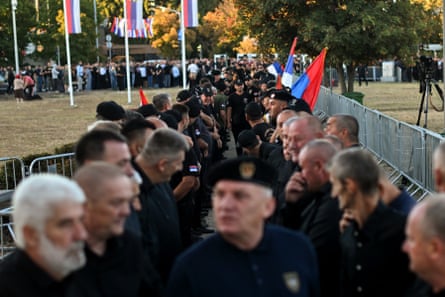 crowd and mourners including Serbian veteran soldiers queuing