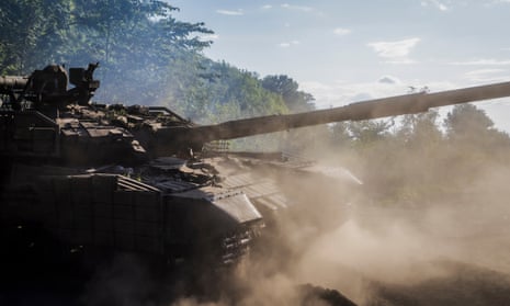 Ukrainian servicemen repair a tank that was evacuated from Russian territory to Ukraine