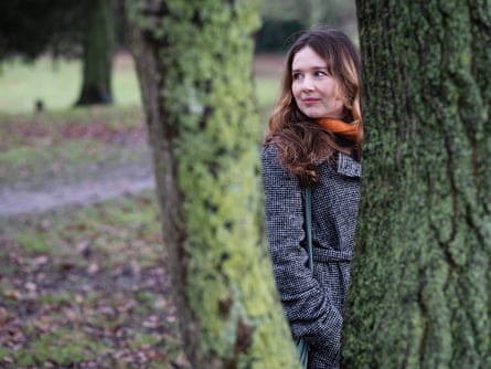 Ella Hopkins surrounded by mossy tree trunks