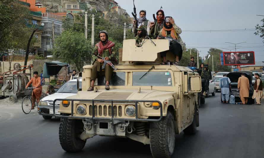 Taliban fighters atop a Humvee take part in a rally in Kabul in August.