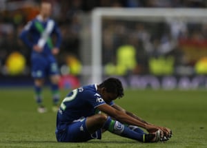 Luiz Gustavo sits on the pitch
