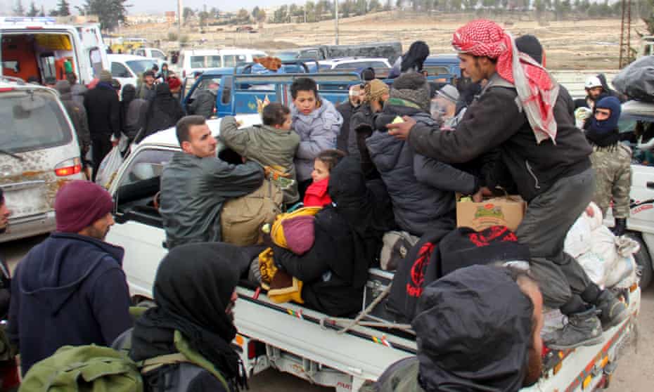 Syrian rebel fighters and civilians evacuated from Aleppo arrive in the opposition-controlled Khan al-Aassal region, west of the city.