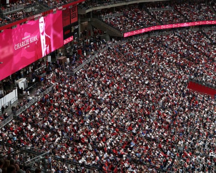 Charlie Kirk shown on screen in a packed stadium