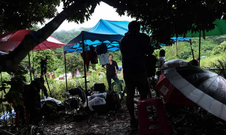 Members of the media report from a hill near the Tham Luang cave area as the operations continue for those still trapped inside the cave