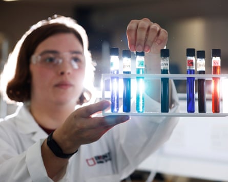 Cara King, R&D scientist at Invinity Energy Systems, holds vials of vanadium electrolyte in its different states of charge.