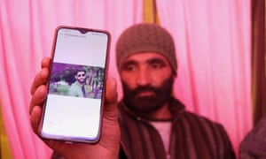 Mohammad Maqbool Ganai shows a picture of his son, Aijaz Maqbool.