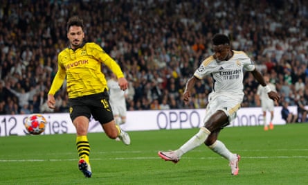Vinícius Júnior scores Real Madrid’s second goal as Mats Hummels watches on.