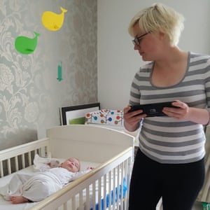 Keza McDonald playing video games while her baby sleeps.