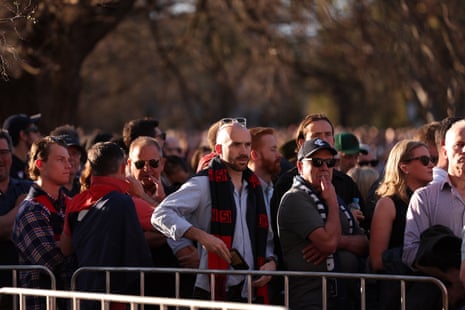 Footy fans queue to get into the MCG