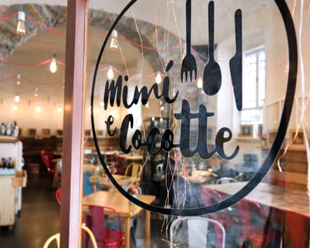 View of the logo of Mimì e Cocotte, which specialises in regional natural wines, on the glass door of its restaurant in Trieste, Italy.