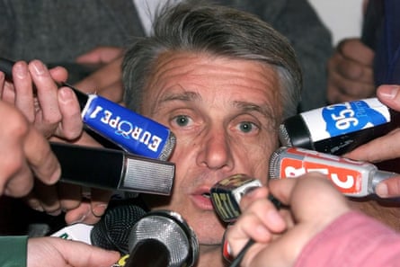 Aimé Jacquet is surrounded by microphones as he answers questions during a press conference in Clairefontaine on 2 July 1998
