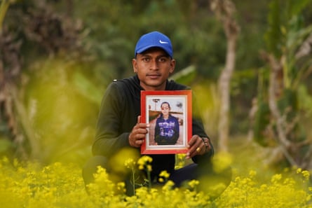 Mohan BK holds a photo of his brother, Suraj