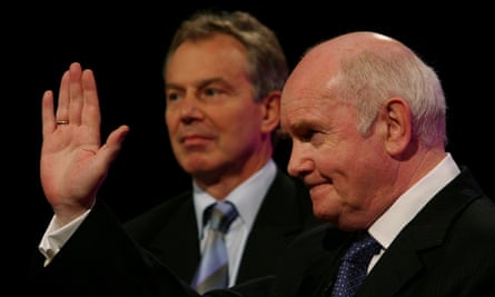 Tony Blair left in background with John Reid hold up his hand
