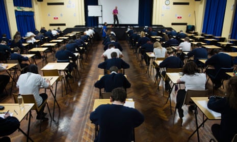 Welsh teenage GCSE school pupils sitting exams in a school hall, Wales UK
