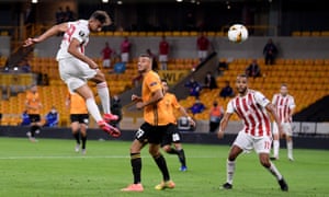 Ahmed Hassan of Olympiacos heads at goal.