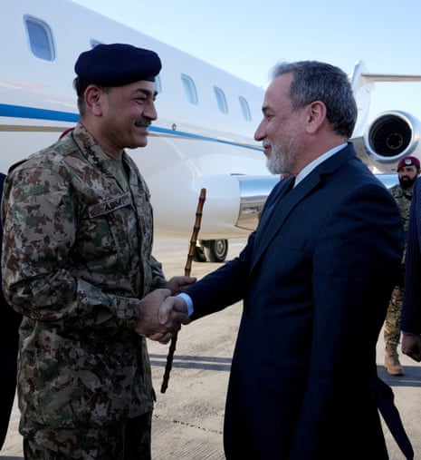 Asim Munir shakes hands with Abbas Araghchi after stepping off a plane at Tehran airport.