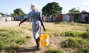 A woman fetches water in Kingston, Jamaica. According to the UN, one in three women in the Caribbean has experienced sexual or physical violence in her lifetime. 