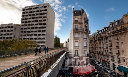 People walk on a bridge of the Petite Ceinture railway from Olivier-de-Serres street to Balard square