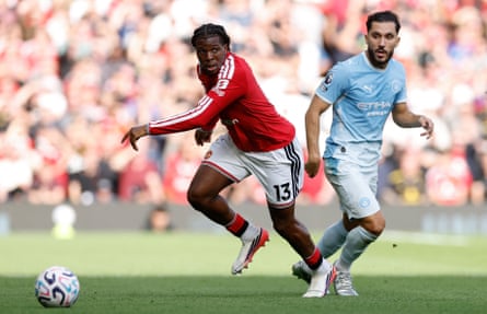 Patrick Dorgu prepares to kick the ball with Rayan Cherki behind