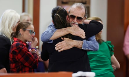 Older man hugs in courtroom
