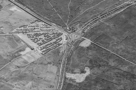 A satellite image provided by Maxar Technologies shows hundreds of trailer trucks – likely carrying aid for Gaza – gather in a new parking area approximately 2 miles south-west of the border in Rafah