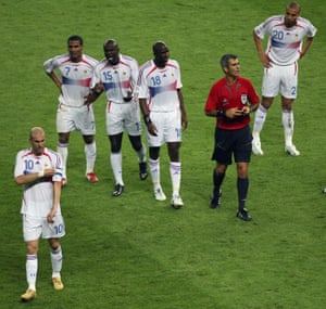 Zidane removes the captain’s armband after receiving the red card from the referee, Horacio Elizondo.