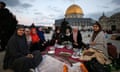 A group of Muslim women sitting with food laid out in front of them