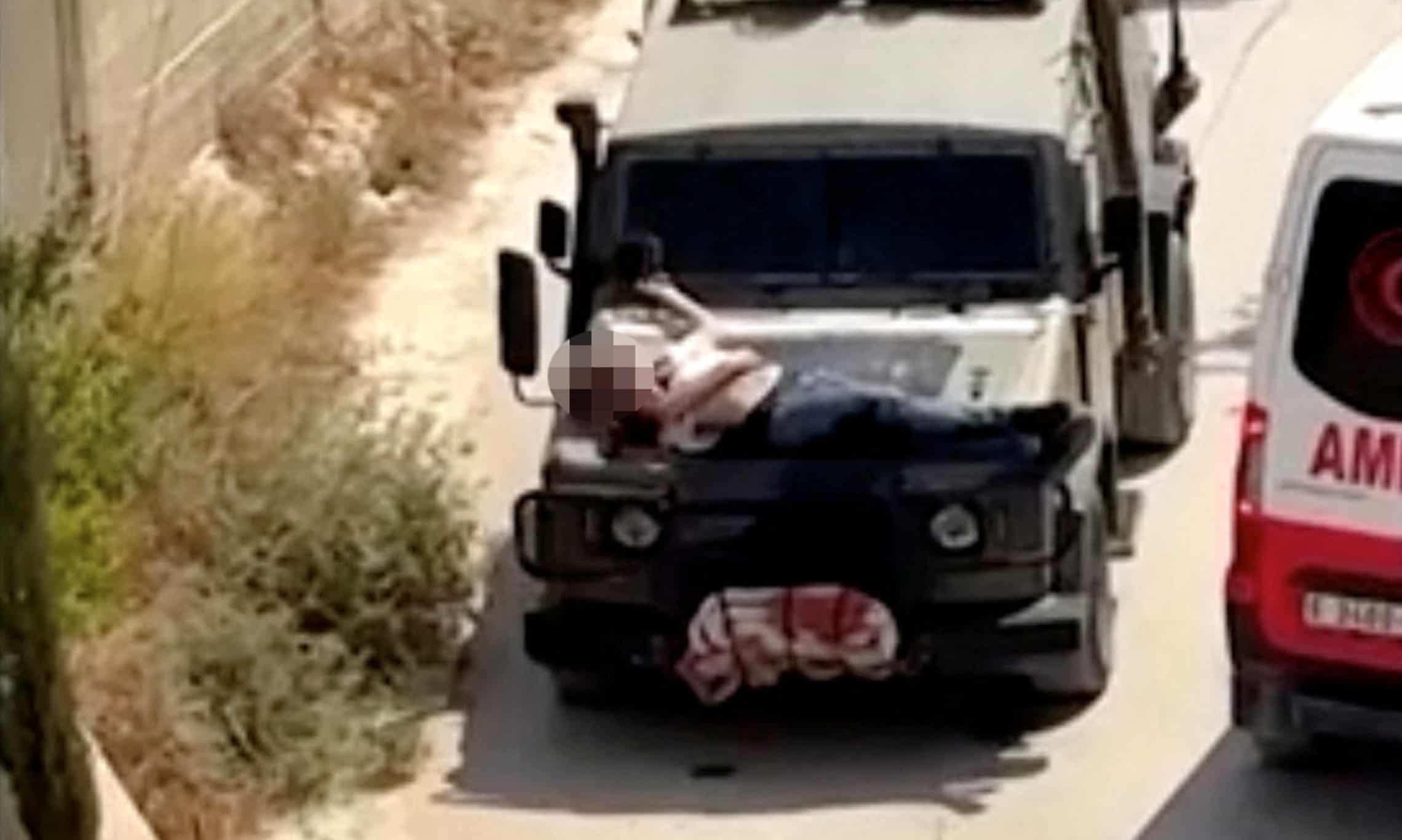 Wounded Palestinian strapped to IDF jeep