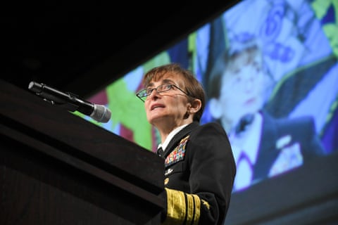 A woman in a uniform speaks into a microphone