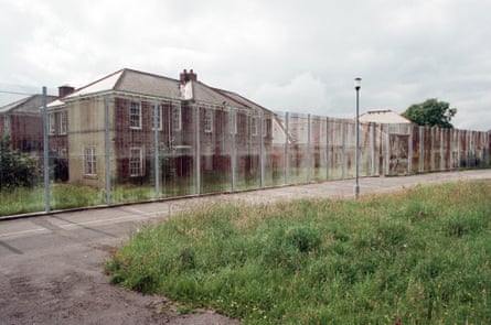 The buildings and surrounding fence of a prison.