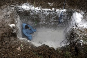 A volunteer prepares a grave at a cemetery on the outskirts of Ghaemshahr, Iran