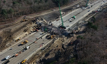 Workmen on the closed section of the M25 between junctions 10 and 11 in Surrey on Saturday 16 March.