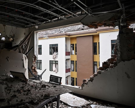A huge hole in the wall of a building, showing the building opposite.