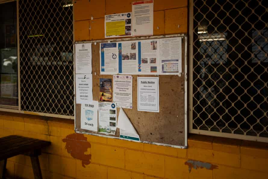 A Queensland Health covid vaccine poster with information on vaccination dates, locations and times is seen on a notice board outside one of two general stroes on Badu Island.