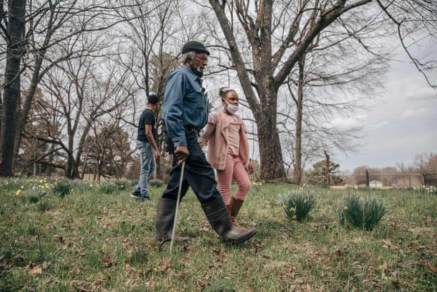 Clyde Robinson and his granddaughter, Aareona Ginns, walk on his land in south-west Memphis.