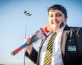 Umar Mahmood in his school uniform carrying a cricket bat over his shoulder.