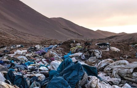 Textile waste strewn across a desert