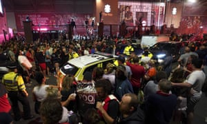 Police officers arrive as Liverpool supporters celebrate outside of Anfield Stadium.